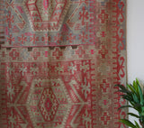 Vintage kilim rug in living room setting, old rug, antique rug, pastel colors, faded colors, Turkish rug, vintage rug, soft rug, Portland, Oregon, rug store, rug shop, local shop, earthy tones, earthy colors, warm colors