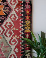Vintage kilim rug in living room setting, old rug, antique rug, pastel colors, faded colors, Turkish rug, vintage rug, soft rug, Portland, Oregon, rug store, rug shop, local shop, earthy tones, earthy colors, warm colors