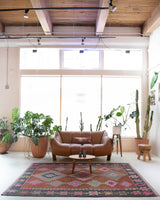 Vintage kilim rug in room decor setting, old rug, antique rug, pastel colors, faded colors, Turkish rug, vintage rug, soft rug, Portland, Oregon, rug store, rug shop, local shop, bold colors, bright colors, faded colors