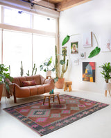 Vintage kilim rug in room decor setting, old rug, antique rug, pastel colors, faded colors, Turkish rug, vintage rug, soft rug, Portland, Oregon, rug store, rug shop, local shop, bold colors, bright colors, faded colors