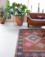 Vintage kilim rug in room decor setting, old rug, antique rug, pastel colors, faded colors, Turkish rug, vintage rug, soft rug, Portland, Oregon, rug store, rug shop, local shop, bold colors, bright colors, faded colors