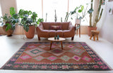 Vintage kilim rug in room decor setting, old rug, antique rug, pastel colors, faded colors, Turkish rug, vintage rug, soft rug, Portland, Oregon, rug store, rug shop, local shop, bold colors, bright colors, faded colors