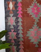 Vintage kilim rug in room decor setting, old rug, antique rug, pastel colors, faded colors, Turkish rug, vintage rug, soft rug, Portland, Oregon, rug store, rug shop, local shop, bold colors, bright colors, faded colors