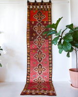Vintage Turkish runner rug in a living room setting, pile rug, Turkish rug, vintage rug, portland, rug shop, bright colors, wild shaman, soft rug, bold color, Portland, Oregon, rug store, rug shop, local shop, antique rug