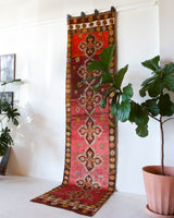 Vintage Turkish runner rug in a living room setting, pile rug, Turkish rug, vintage rug, portland, rug shop, bright colors, wild shaman, soft rug, bold color, Portland, Oregon, rug store, rug shop, local shop, antique rug