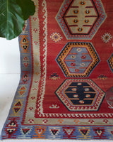 Vintage kilim rug in room decor setting, old rug, antique rug, pastel colors, faded colors, Turkish rug, vintage rug, soft rug, Portland, Oregon, rug store, rug shop, local shop, bold colors, bright colors, faded colors