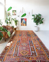 Vintage kilim rug in room decor setting, old rug, antique rug, pastel colors, faded colors, Turkish rug, vintage rug, soft rug, Portland, Oregon, rug store, rug shop, local shop, bold colors, bright colors, faded colors