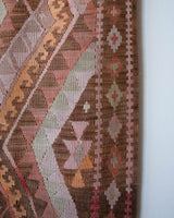 Vintage kilim rug in living room setting, old rug, antique rug, pastel colors, faded colors, Turkish rug, vintage rug, soft rug, Portland, Oregon, rug store, rug shop, local shop, earthy tones, earthy colors, warm colors