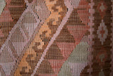 Vintage kilim rug in living room setting, old rug, antique rug, pastel colors, faded colors, Turkish rug, vintage rug, soft rug, Portland, Oregon, rug store, rug shop, local shop, earthy tones, earthy colors, warm colors
