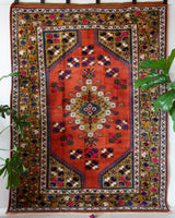 Vintage Turkish rug in a living room setting, pile rug, Turkish rug, vintage rug, portland, rug shop, bright colors, wild shaman, soft rug, bold color, Portland, Oregon, rug store, rug shop, local shop, antique rug