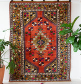 Vintage Turkish rug in a living room setting, pile rug, Turkish rug, vintage rug, portland, rug shop, bright colors, wild shaman, soft rug, bold color, Portland, Oregon, rug store, rug shop, local shop, antique rug