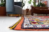 Vintage Turkish rug in a living room setting, pile rug, Turkish rug, vintage rug, portland, rug shop, bright colors, wild shaman, soft rug, bold color, Portland, Oregon, rug store, rug shop, local shop, antique rug