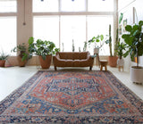 Antique Persian area rug in a living room setting, pile rug, vintage rug, portland, rug shop, bright colors, wild shaman, soft rug, bold color, Portland, Oregon, rug store, rug shop, local shop, antique rug, Persian rug, handmade rug, wool rug, distressed rug
