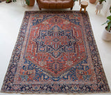 Antique Persian area rug in a living room setting, pile rug, vintage rug, portland, rug shop, bright colors, wild shaman, soft rug, bold color, Portland, Oregon, rug store, rug shop, local shop, antique rug, Persian rug, handmade rug, wool rug, distressed rug