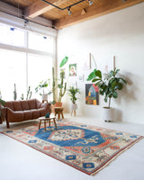 Vintage Turkish rug in living room setting, old rug, antique rug, pastel colors, faded colors, Turkish rug, vintage rug, soft rug, Portland, Oregon, rug store, rug shop, local shop