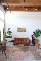 Vintage kilim rug in room decor setting, old rug, antique rug, pastel colors, faded colors, Turkish rug, vintage rug, soft rug, Portland, Oregon, rug store, rug shop, local shop, distressed rug, worn out rug