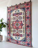 Vintage Turkish rug in a living room setting, pile rug, Turkish rug, vintage rug, portland, rug shop, bright colors, wild shaman, soft rug, bold color, Portland, Oregon, rug store, rug shop, local shop