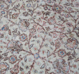 Area rug in a living room setting, pile rug, Turkish rug, old rug, antique rug, pastel colors, faded colors, Turkish rug, vintage rug, soft rug, Portland, Oregon, rug store, rug shop, local shop, distressed rug, worn out rug