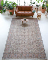 Area rug in a living room setting, pile rug, Turkish rug, old rug, antique rug, pastel colors, faded colors, Turkish rug, vintage rug, soft rug, Portland, Oregon, rug store, rug shop, local shop, distressed rug, worn out rug
