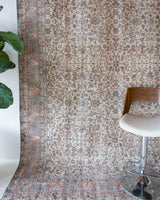 Area rug in a living room setting, pile rug, Turkish rug, old rug, antique rug, pastel colors, faded colors, Turkish rug, vintage rug, soft rug, Portland, Oregon, rug store, rug shop, local shop, distressed rug, worn out rug