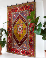 Vintage Turkish rug in a living room setting, pile rug, Turkish rug, vintage rug, portland, rug shop, bright colors, wild shaman, soft rug, bold color, Portland, Oregon, rug store, rug shop, local shop, antique rug