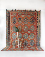 Vintage kilim rug in room decor setting, old rug, antique rug, pastel colors, faded colors, Turkish rug, vintage rug, soft rug, Portland, Oregon, rug store, rug shop, local shop, bold colors, bright colors, faded colors