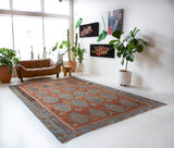 Vintage kilim rug in room decor setting, old rug, antique rug, pastel colors, faded colors, Turkish rug, vintage rug, soft rug, Portland, Oregon, rug store, rug shop, local shop, bold colors, bright colors, faded colors