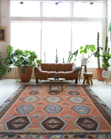 Vintage kilim rug in room decor setting, old rug, antique rug, pastel colors, faded colors, Turkish rug, vintage rug, soft rug, Portland, Oregon, rug store, rug shop, local shop, bold colors, bright colors, faded colors