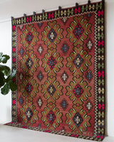 Vintage kilim rug in room decor setting, old rug, antique rug, pastel colors, faded colors, Turkish rug, vintage rug, soft rug, Portland, Oregon, rug store, rug shop, local shop, bold colors, bright colors, faded colors