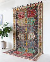 Vintage kilim rug in room decor setting, old rug, antique rug, pastel colors, faded colors, Turkish rug, vintage rug, soft rug, Portland, Oregon, rug store, rug shop, local shop, bold colors, bright colors, faded colors