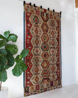 Vintage kilim rug in living room setting, old rug, antique rug, pastel colors, faded colors, Turkish rug, vintage rug, soft rug, Portland, Oregon, rug store, rug shop, local shop, earthy tones, earthy colors, warm colors