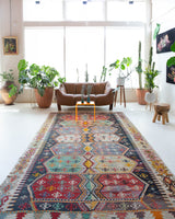 Vintage kilim rug in room decor setting, old rug, antique rug, pastel colors, faded colors, Turkish rug, vintage rug, soft rug, Portland, Oregon, rug store, rug shop, local shop, bold colors, bright colors, faded colors