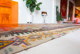 Vintage kilim rug in room decor setting, old rug, antique rug, pastel colors, faded colors, Turkish rug, vintage rug, soft rug, Portland, Oregon, rug store, rug shop, local shop, bold colors, bright colors, faded colors