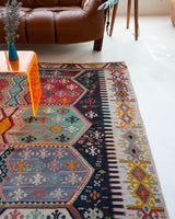 Vintage kilim rug in room decor setting, old rug, antique rug, pastel colors, faded colors, Turkish rug, vintage rug, soft rug, Portland, Oregon, rug store, rug shop, local shop, bold colors, bright colors, faded colors