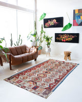 Vintage kilim rug in living room setting, old rug, antique rug, pastel colors, faded colors, Turkish rug, vintage rug, soft rug, Portland, Oregon, rug store, rug shop, local shop, earthy tones, earthy colors, warm colors