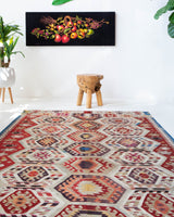 Vintage kilim rug in living room setting, old rug, antique rug, pastel colors, faded colors, Turkish rug, vintage rug, soft rug, Portland, Oregon, rug store, rug shop, local shop, earthy tones, earthy colors, warm colors