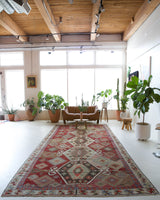 Vintage kilim rug in room decor setting, old rug, antique rug, pastel colors, faded colors, Turkish rug, vintage rug, soft rug, Portland, Oregon, rug store, rug shop, local shop, bold colors, bright colors, faded colors