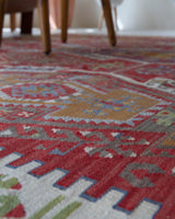 Vintage kilim rug in room decor setting, old rug, antique rug, pastel colors, faded colors, Turkish rug, vintage rug, soft rug, Portland, Oregon, rug store, rug shop, local shop, bold colors, bright colors, faded colors