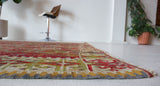Vintage kilim rug in room decor setting, old rug, antique rug, pastel colors, faded colors, Turkish rug, vintage rug, soft rug, Portland, Oregon, rug store, rug shop, local shop, bold colors, bright colors, faded colors