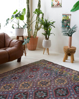 Vintage kilim rug in room decor setting, old rug, antique rug, pastel colors, faded colors, Turkish rug, vintage rug, soft rug, Portland, Oregon, rug store, rug shop, local shop, bold colors, bright colors, faded colors