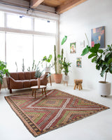 Vintage kilim rug in room decor setting, old rug, antique rug, pastel colors, faded colors, Turkish rug, vintage rug, soft rug, Portland, Oregon, rug store, rug shop, local shop, bold colors, bright colors, faded colors