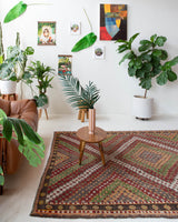 Vintage kilim rug in room decor setting, old rug, antique rug, pastel colors, faded colors, Turkish rug, vintage rug, soft rug, Portland, Oregon, rug store, rug shop, local shop, bold colors, bright colors, faded colors