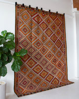 Vintage kilim rug in room decor setting, old rug, antique rug, pastel colors, faded colors, Turkish rug, vintage rug, soft rug, Portland, Oregon, rug store, rug shop, local shop, bold colors, bright colors, faded colors