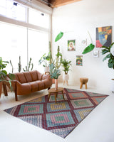 Vintage kilim rug in living room setting, old rug, antique rug, pastel colors, faded colors, Turkish rug, vintage rug, soft rug, Portland, Oregon, rug store, rug shop, local shop, earthy tones, earthy colors, warm colors