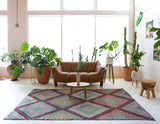 Vintage kilim rug in living room setting, old rug, antique rug, pastel colors, faded colors, Turkish rug, vintage rug, soft rug, Portland, Oregon, rug store, rug shop, local shop, earthy tones, earthy colors, warm colors