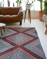 Vintage kilim rug in living room setting, old rug, antique rug, pastel colors, faded colors, Turkish rug, vintage rug, soft rug, Portland, Oregon, rug store, rug shop, local shop, earthy tones, earthy colors, warm colors