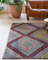 Vintage kilim rug in living room setting, old rug, antique rug, pastel colors, faded colors, Turkish rug, vintage rug, soft rug, Portland, Oregon, rug store, rug shop, local shop, earthy tones, earthy colors, warm colors