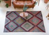 Vintage kilim rug in living room setting, old rug, antique rug, pastel colors, faded colors, Turkish rug, vintage rug, soft rug, Portland, Oregon, rug store, rug shop, local shop, earthy tones, earthy colors, warm colors