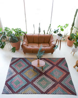 Vintage kilim rug in living room setting, old rug, antique rug, pastel colors, faded colors, Turkish rug, vintage rug, soft rug, Portland, Oregon, rug store, rug shop, local shop, earthy tones, earthy colors, warm colors