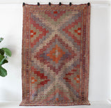 Vintage kilim rug in living room setting, old rug, antique rug, pastel colors, faded colors, Turkish rug, vintage rug, soft rug, Portland, Oregon, rug store, rug shop, local shop, earthy tones, earthy colors, warm colors